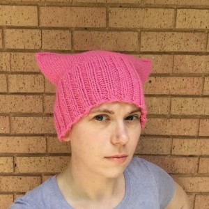 A person wearing a pink hat with ears.
