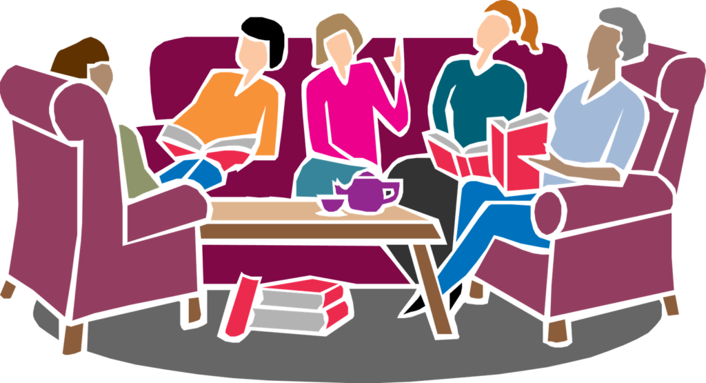 A group of people sitting around a table with books.